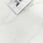 Livre ouvert sur table marbre blanc veiné.